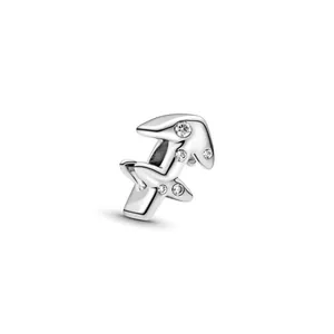 Macro shot of silver Sagittarius charm featuring sparkling crystal stones and polished finish