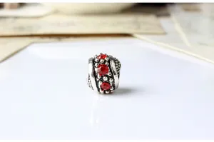Detail of vintage silver bead with red crystals and textured grain for DIY bracelets