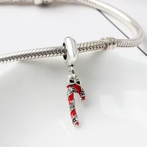 Macro shot of silver snake chain bracelet with red enamel Christmas candy cane charm