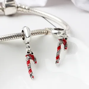 Macro detail of Christmas candy cane charms with red enamel on a silver snake chain