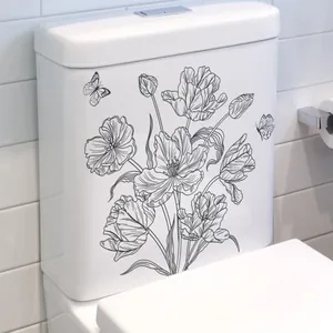 Detail showing elegant black floral tulip and butterfly stickers on a white toilet tank