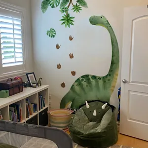 Detail of watercolor green brachiosaurus wall decal with tropical leaves and footprints