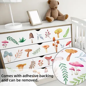 Macro detail of watercolor mushroom wall decals showing adhesive backing on wood furniture