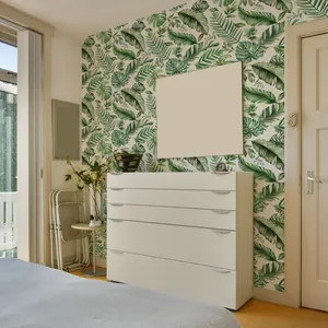 Close-up of tropical green leaves wallpaper featuring palm and monstera leaf patterns