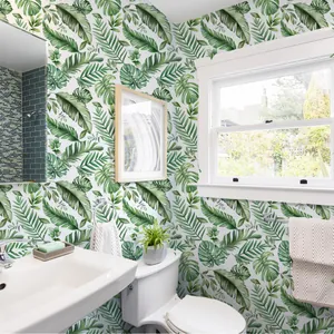 Modern tropical green leaf wallpaper featuring monstera and palm leaves in a bathroom