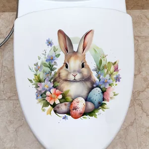 Détail d'autocollant lapin de Pâques et œufs colorés sur un abattant de WC blanc