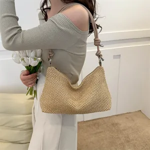 Minimalist woven straw tote bag for women featuring khaki leather straps and top zipper