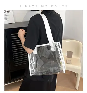 Detail of transparent PVC tote bag with white reinforced webbing and graphic text print