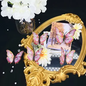 Detail of 3D butterfly wall stickers with pink gradient wings and golden edges for decor