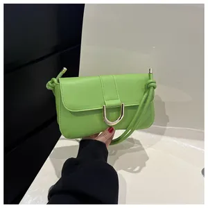 Detail of avocado green leather shoulder bag with gold D-buckle and knotted strap