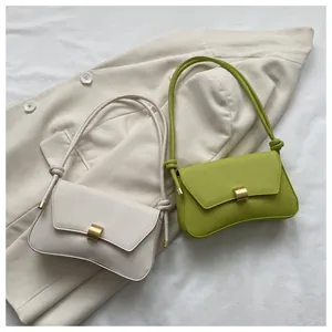 Detail of cream and green baguette bags with gold buckle and knotted shoulder straps