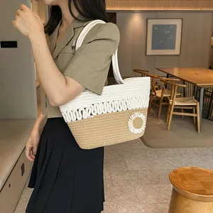 Stylish woven summer tote bag with white flower charm and natural straw texture for travel