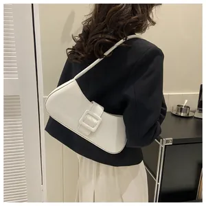 Model view of an elegant white half-moon baguette bag worn as a shoulder underarm bag