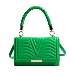 Bright green quilted leather handbag with woven handle and gold hardware detail