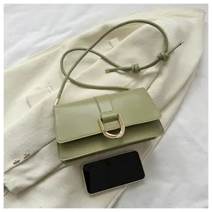 Top view of sage green rectangular crossbody bag with golden horseshoe buckle and cord strap
