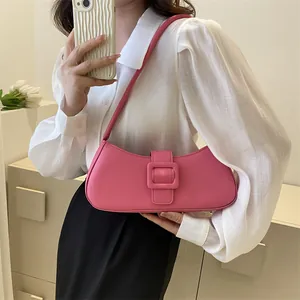 Chic pink crescent hobo bag with a matching square buckle strap for a minimalist look