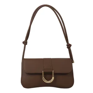 Chic dark brown faux leather underarm bag with elegant gold U-shaped metal buckle