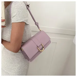 Detail of lavender baguette bag showing golden buckle and knot shoulder strap