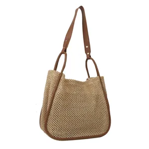 Grande borsa tote in paglia intrecciata con manici in pelle marrone e rivetti
