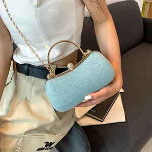 Elegant light blue glitter clutch bag with golden handle and rhinestone clasp for evening parties
