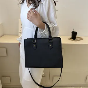 Classic black Saffiano leather large tote bag with gold hardware and dual top handles