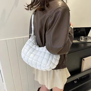 Detail view of the white quilted puffy shoulder bag made of lightweight nylon fabric