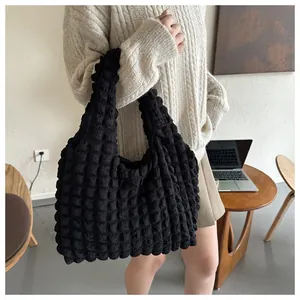 Detailed close-up of textured bubble surface on a black large capacity tote bag