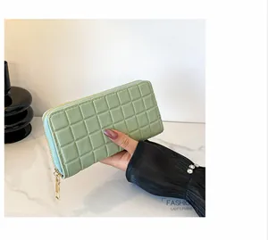 Detail of light green quilted long wallet for women with golden zipper and fashion design