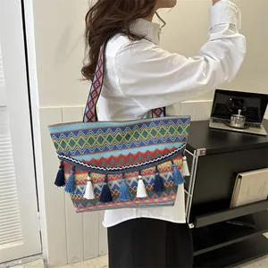 Bohemian canvas tote bag with colorful ethnic patterns and decorative tassels on side