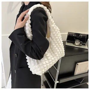Detailed macro of white popcorn texture fabric on a stylish underarm shoulder bag