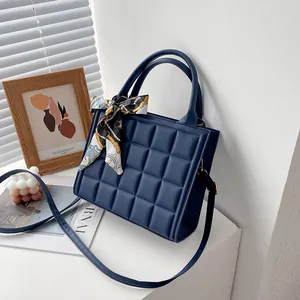 Dark blue plaid embossed crossbody bag with decorative silk scarf and golden hardware