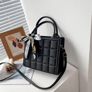 Black puffy grid square handbag with silk scarf bow and adjustable shoulder strap