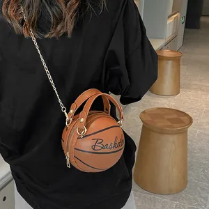 Unique basketball-shaped crossbody bag with gold chain strap and letter details