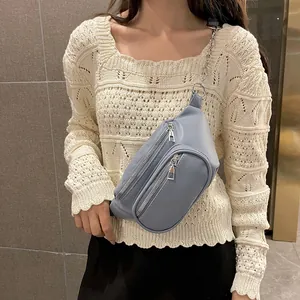 Sac bandoulière en cuir PU bleu-gris avec double zip et chaîne en métal porté par mannequin