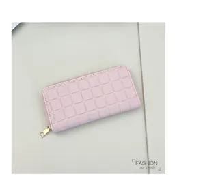 Top view of pink long wallet with square quilted pattern and gold zipper detail