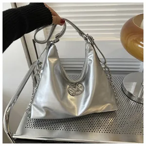 Detailed macro view of silver metallic hobo bag with round logo and chain strap