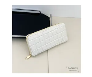 Detail of white long checkered wallet with golden metal zipper on minimalist geometric base
