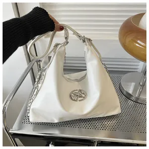 Close-up of a white leather Hobo bag featuring a silver metal logo and chain detail