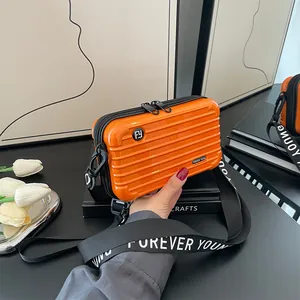 Fashionable orange suitcase style hardshell crossbody bag with striped texture and wide strap