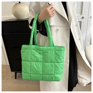 Detailed close-up of vibrant green quilted puffer tote bag with square stitching