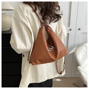 Brown leather crossbody bag with silver chain strap and triangular geometric design