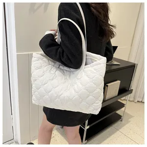 Close-up of white quilted puffer tote bag showing large capacity and quilted texture