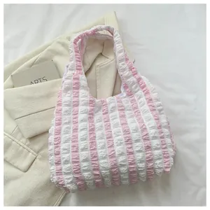Detail of pink and white striped seersucker tote bag with soft pleated texture