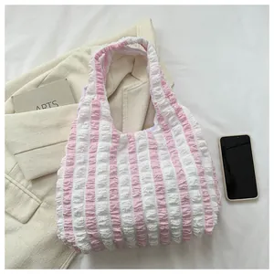 Detail view of pink and white striped puffy tote bag with unique bubble texture finish