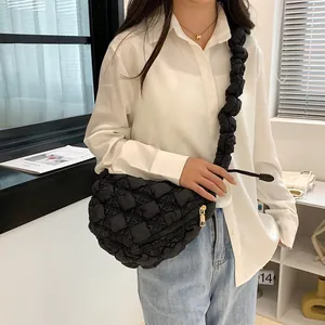Detail of black quilted cloud shoulder bag showing ruched texture and golden zipper