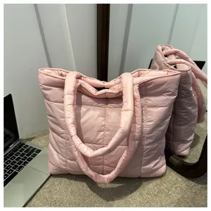 Close-up of pink quilted puffer tote bag with square pattern and soft fabric texture