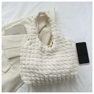 Detail of off-white puff cloud tote bag featuring unique popcorn textured fabric