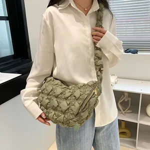 Detail of olive green cloud bag with quilted bubble texture and wide shoulder strap