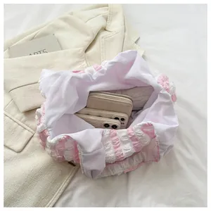 Interior view of pink striped puff handbag showing space for smartphone and wallet