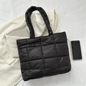 Quilted down cotton tote bag in black square pattern shown in a lifestyle scene